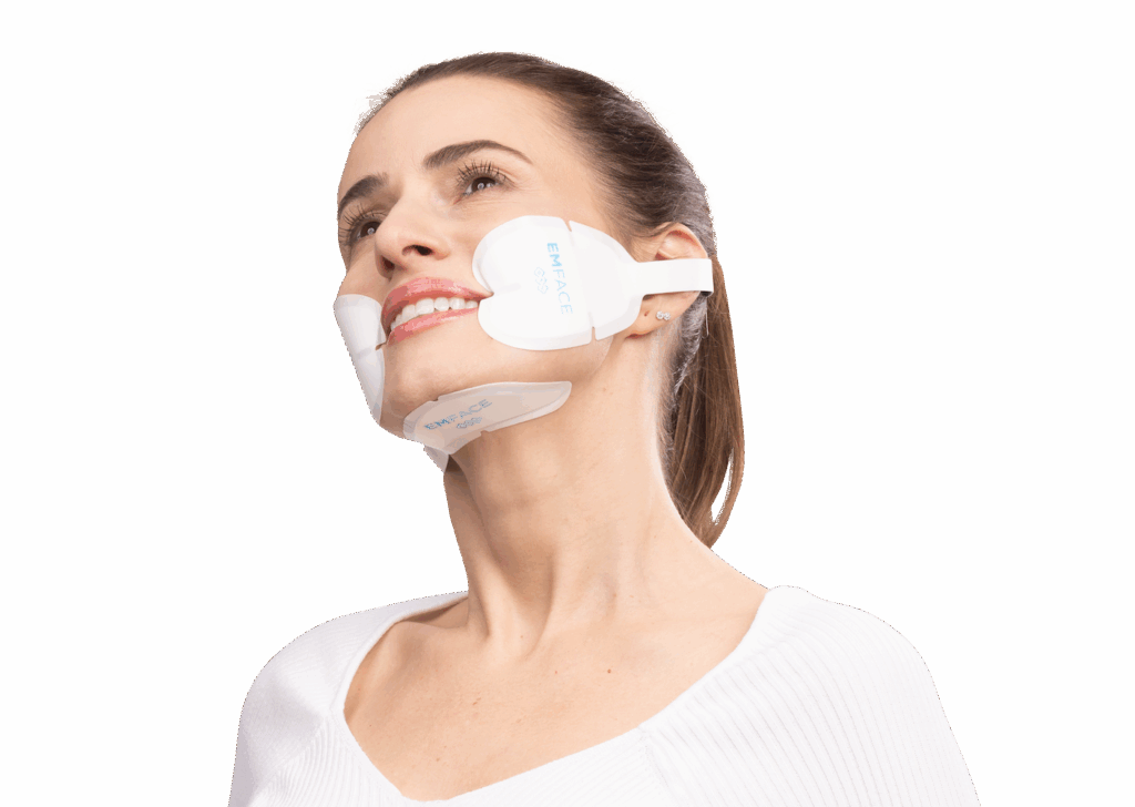 A woman undergoing an Emface facial rejuvenation treatment, with applicators placed on her cheeks and forehead, demonstrating the non-invasive procedure available at Elite Healthcare Partners in Wellington, FL.